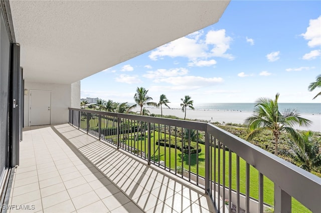 balcony with a water view and a beach view