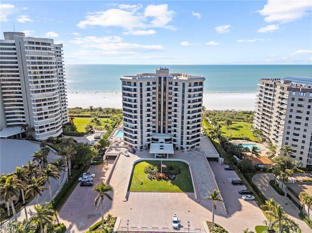 birds eye view of property featuring a water view and a beach view