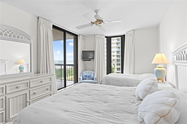 bedroom featuring access to exterior, ceiling fan, and a wall of windows