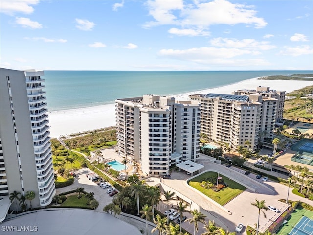 drone / aerial view featuring a water view and a beach view