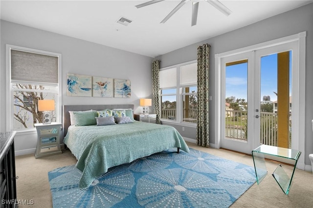 bedroom featuring multiple windows, light colored carpet, ceiling fan, and access to outside