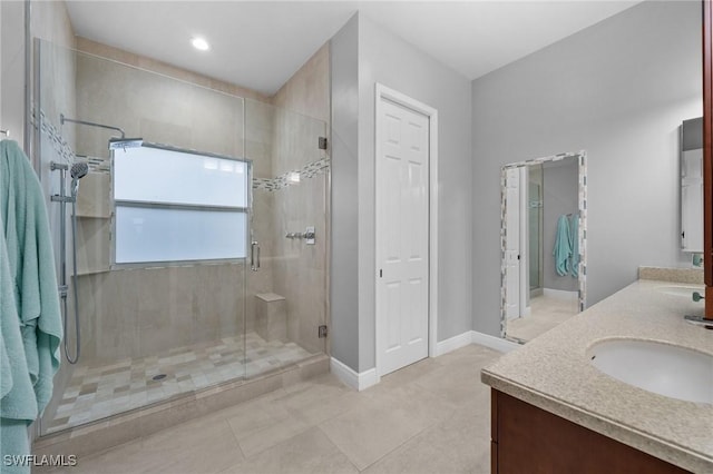 bathroom featuring walk in shower, vanity, and tile patterned flooring