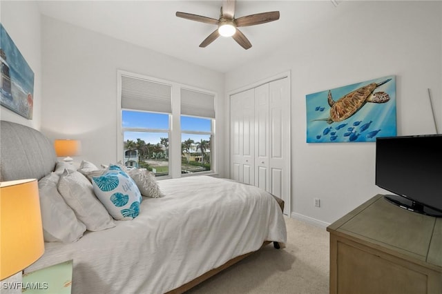 carpeted bedroom with a closet and ceiling fan