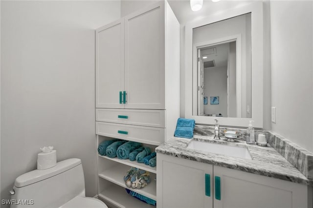 bathroom with toilet and vanity