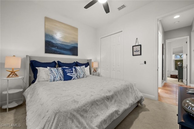 carpeted bedroom featuring a closet and ceiling fan