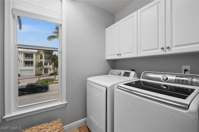 laundry area featuring cabinets and washing machine and dryer