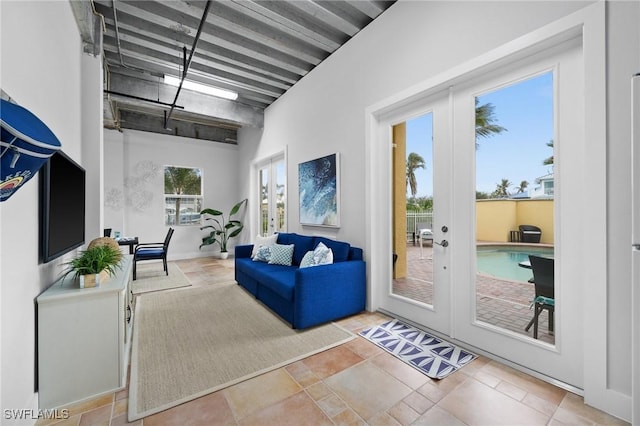 interior space with french doors and beam ceiling