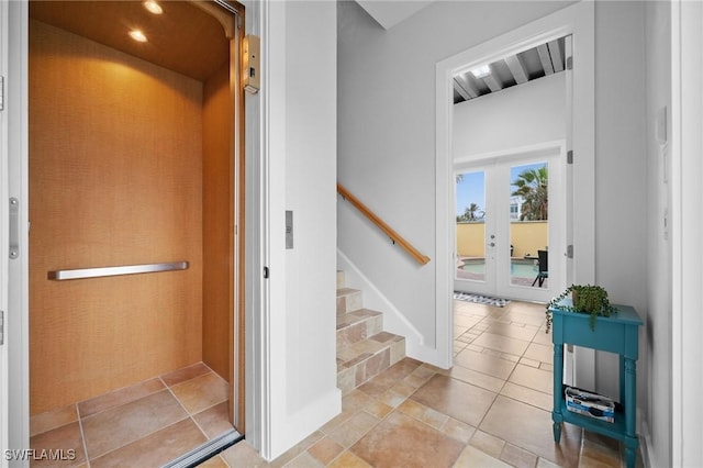 stairs with elevator and french doors