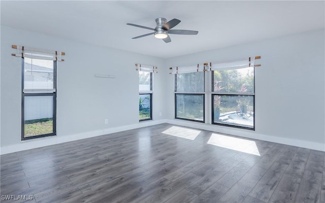 unfurnished room with ceiling fan, plenty of natural light, and dark hardwood / wood-style floors