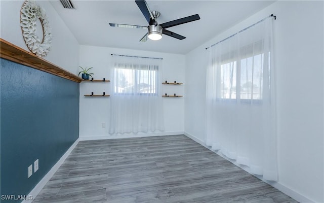 empty room featuring wood-type flooring and ceiling fan