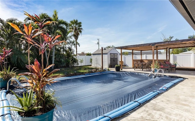 view of pool featuring a patio and a storage unit