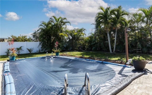 view of swimming pool featuring a lawn