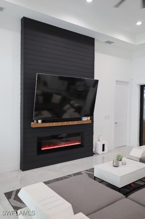 living room featuring a large fireplace