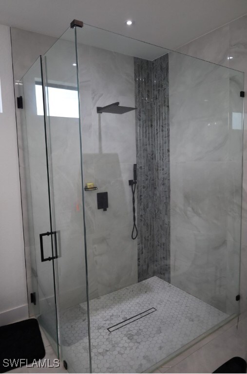 bathroom with a shower with door