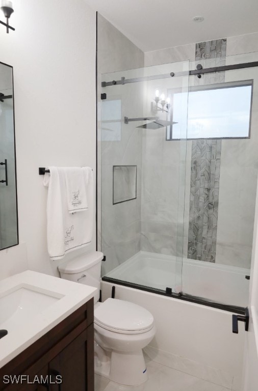 full bathroom with combined bath / shower with glass door, vanity, toilet, and tile patterned flooring