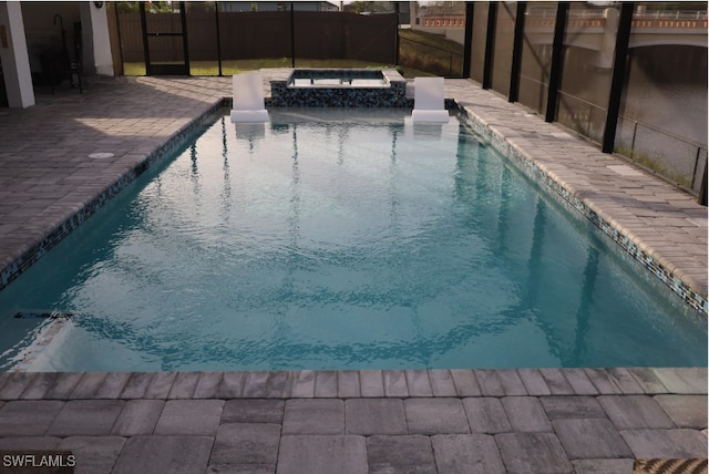 view of swimming pool featuring an in ground hot tub and a patio