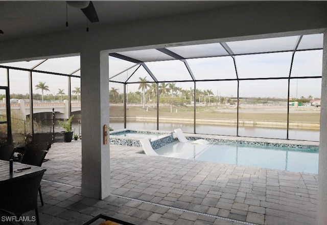 view of swimming pool with a water view, a lanai, an in ground hot tub, and a patio