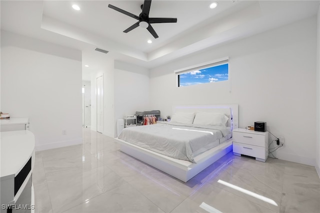 bedroom with a ceiling fan, a tray ceiling, recessed lighting, and baseboards