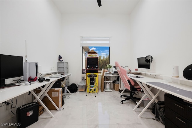 office featuring marble finish floor and ceiling fan