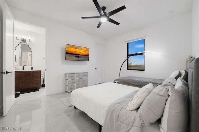 bedroom featuring ensuite bath and a ceiling fan