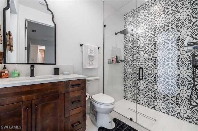 bathroom with visible vents, toilet, vanity, and walk in shower