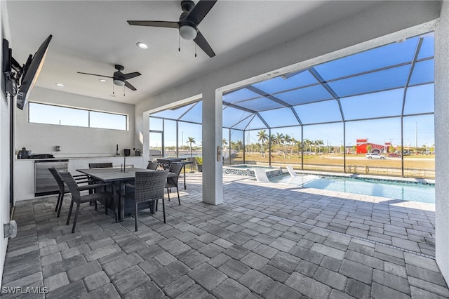 view of patio / terrace with outdoor dining space, glass enclosure, a pool with connected hot tub, and ceiling fan