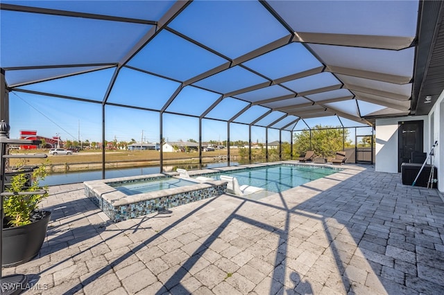 view of swimming pool featuring a patio, a lanai, and a pool with connected hot tub