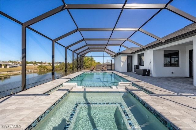 view of pool with glass enclosure, a patio area, a water view, and a pool with connected hot tub