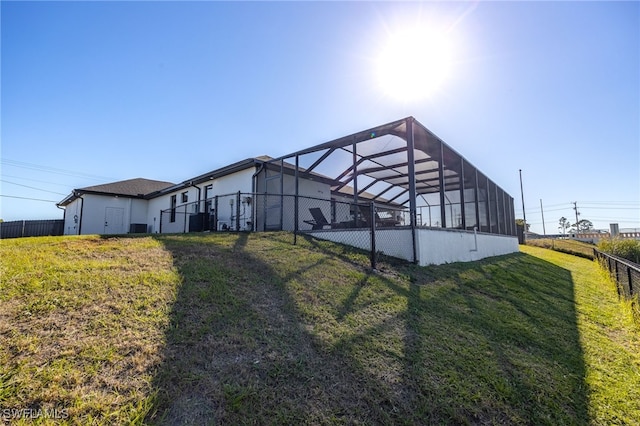 exterior space with glass enclosure, central AC, and fence