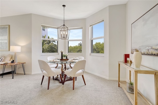 dining area featuring light carpet and a chandelier