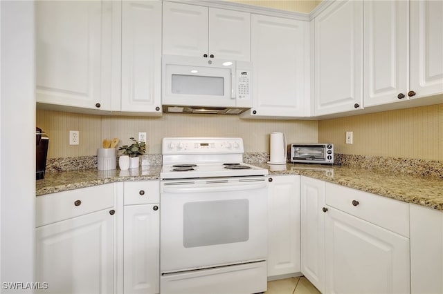 kitchen with white cabinetry, light stone countertops, and white appliances