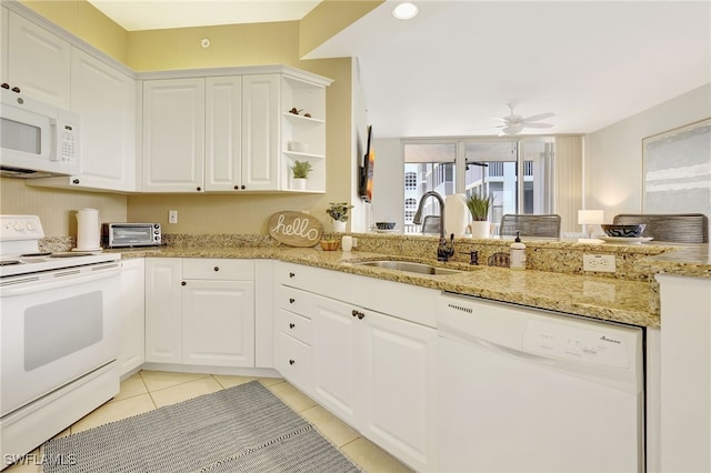 kitchen featuring white cabinets, light tile patterned floors, white appliances, and sink