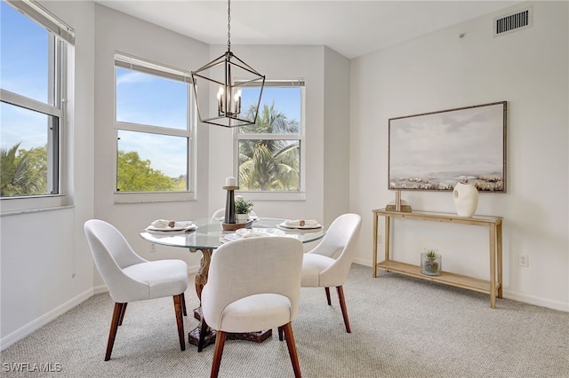 dining room featuring carpet and a notable chandelier