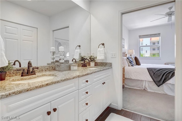 bathroom with ceiling fan, hardwood / wood-style floors, and vanity