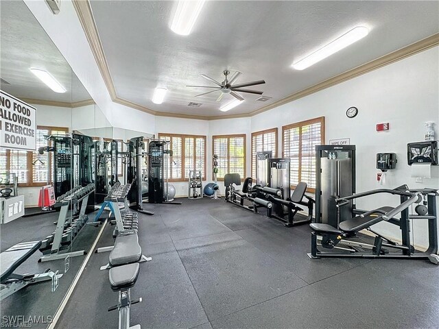 gym featuring a textured ceiling, ceiling fan, and crown molding