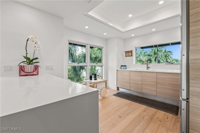 bedroom featuring sink and light hardwood / wood-style flooring