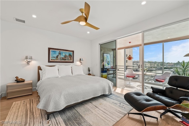 bedroom featuring ceiling fan, light hardwood / wood-style floors, and access to outside