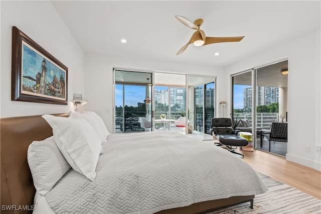 bedroom with hardwood / wood-style flooring, access to outside, and ceiling fan