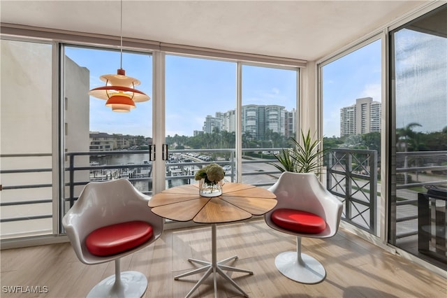 sunroom featuring a water view