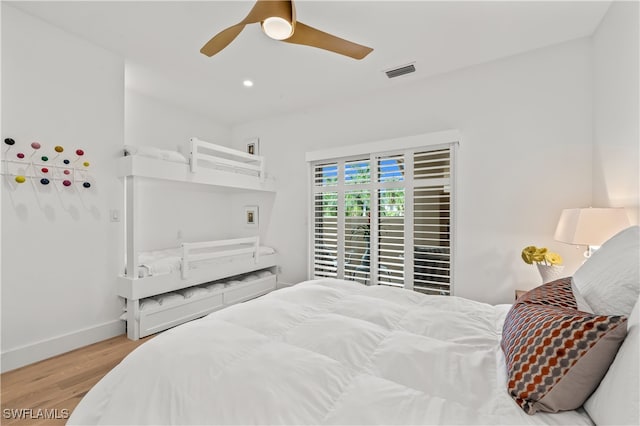 bedroom with light hardwood / wood-style floors and ceiling fan