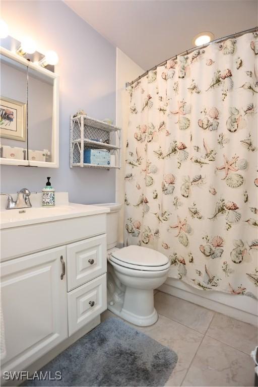 full bathroom with tile patterned flooring, vanity, toilet, and shower / bathtub combination with curtain