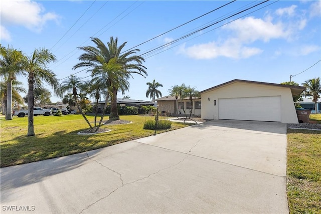 view of front of home with a garage and a front lawn