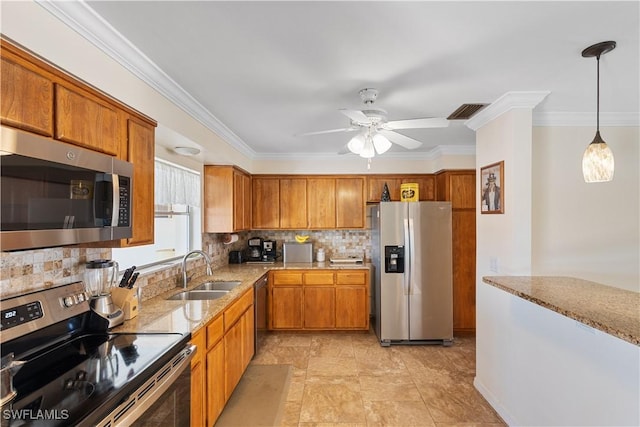 kitchen with sink, decorative light fixtures, ornamental molding, appliances with stainless steel finishes, and decorative backsplash