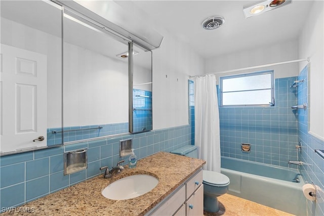 full bathroom featuring tile walls, vanity, shower / bath combination with curtain, and toilet