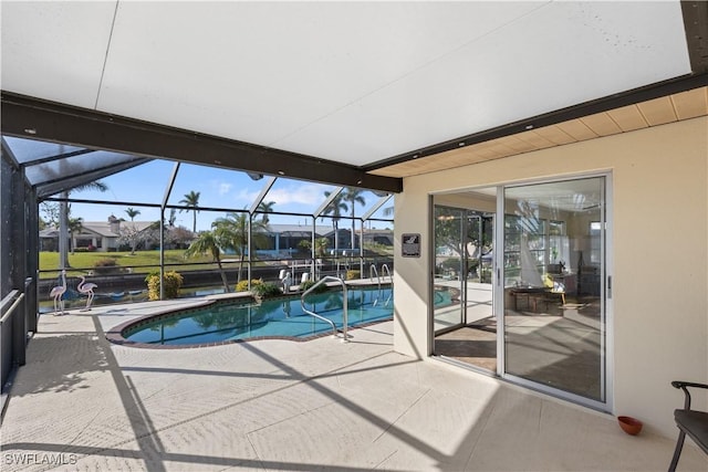 view of swimming pool with glass enclosure and a patio area