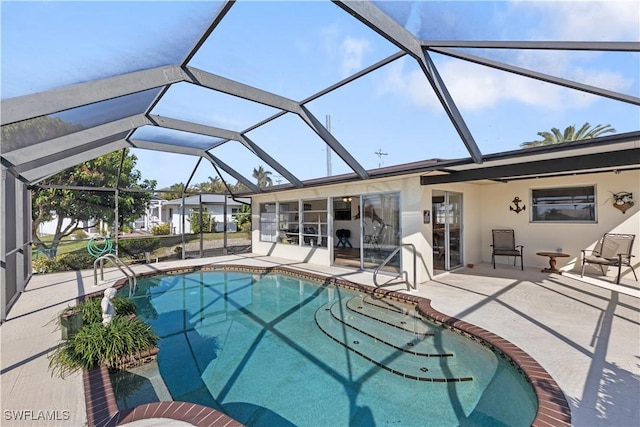 view of pool featuring a patio and glass enclosure