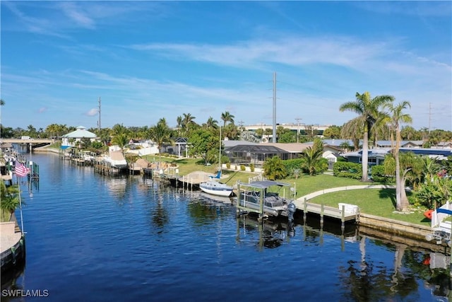 dock area with a water view and a yard