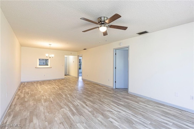 unfurnished room featuring ceiling fan with notable chandelier, a textured ceiling, and light wood-type flooring