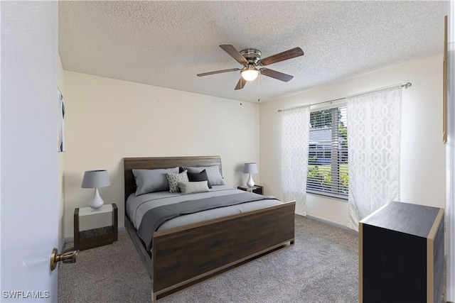 carpeted bedroom featuring a textured ceiling and ceiling fan