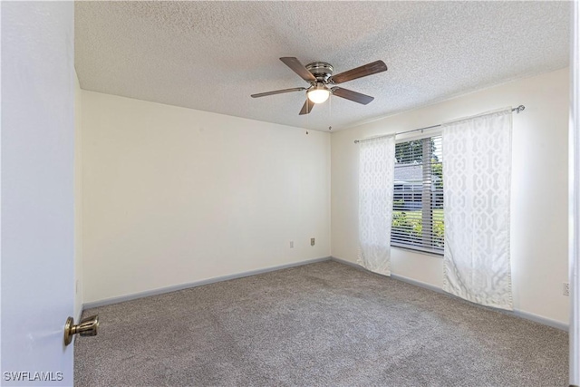 unfurnished room featuring ceiling fan, carpet, and a textured ceiling